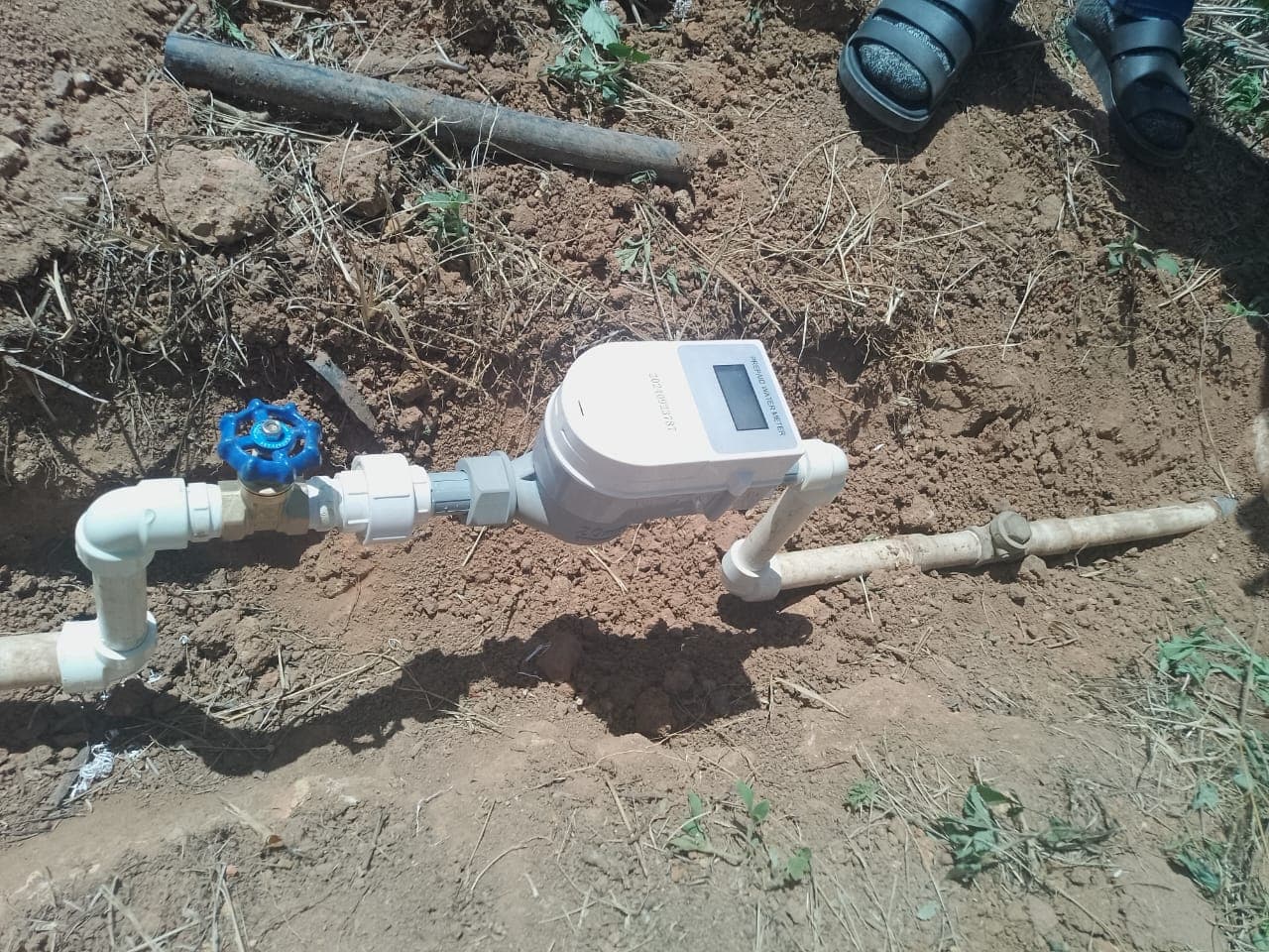 SH prepaid water meter installed on a trench lateral with gate valve, actual field photo
